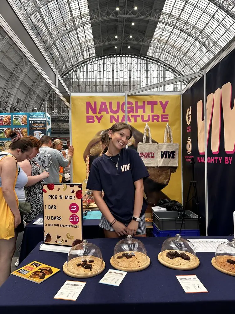 Vive stand at a station event with sample cookies under glass domes