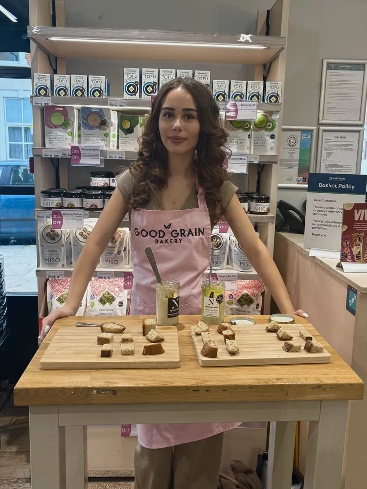 Good Grain Bakery sampling stand with bread samples on boards